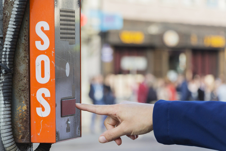 A fragment of the emergency terminal. The girl asks for help. SOS button.の写真素材