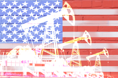 silhouette of oil drilling pump on background of united states flag.の写真素材