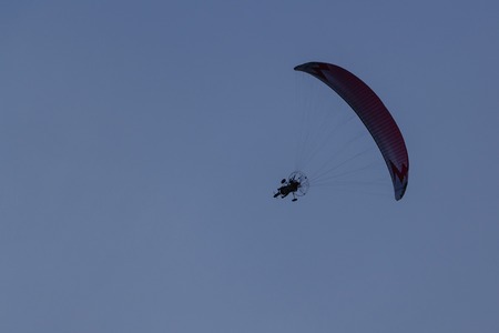 people paragliding fly in the sky evening sunset time for their hobby and adventure sport.の写真素材