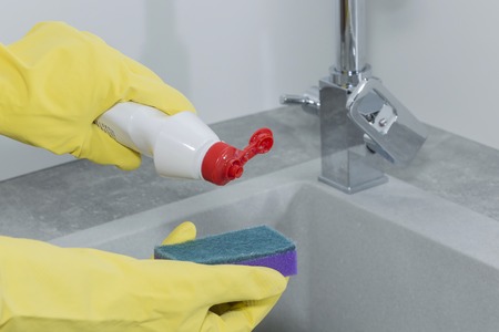 female hands close-up, wash the dishes in the kitchenの写真素材