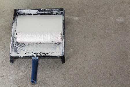 Close up of painter im painting a wall with paint roller.の写真素材