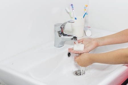 Hygiene concept. Washing hands with soap under the faucet with water.の写真素材