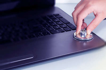 Stethoscope on laptop keyboard. Health care or IT security conceptの写真素材