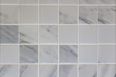 The stone floor is decorated with a variety of geometric mosaic, blue, red, white, black tile....