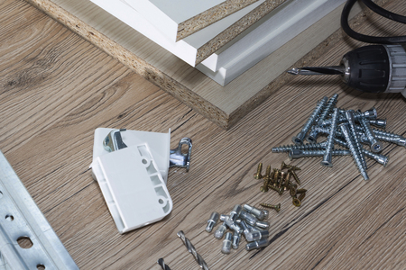Installation of chipboard furniture in a carpentry workshop. Accessories and tools for carpenters.の写真素材