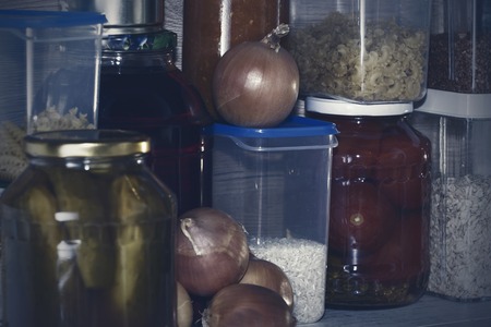 Storage shelves in pantry with homemade canned preserved fruits and vegetablesの写真素材