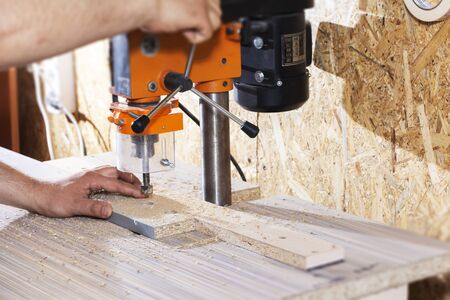 Drill in the drilling machine, making furniture.