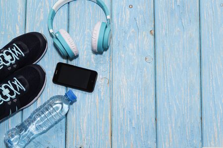 sports shoes, water bottle on blue background concept of healthy living, healthy eating, sports and diet.の写真素材
