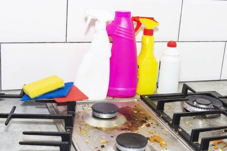 Dirty, top of the gas stove with bits of food. House cleaning.の写真素材
