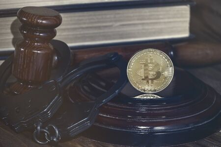 bitcoin, judge's hammer, handcuffs. Concept bitcoin ban, violation of the law