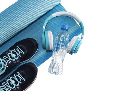Yoga Mat, sports shoes, water bottle concept of healthy living, healthy eating, sports and diet.