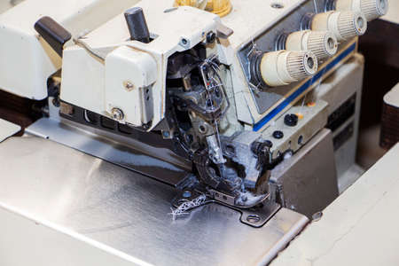 Four-thread industrial sewing machine overlock. An overlock is a type of stitch that sews along the...