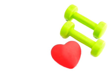 Dumbbells and a red heart on a white background. The concept of a healthy lifestyleの写真素材