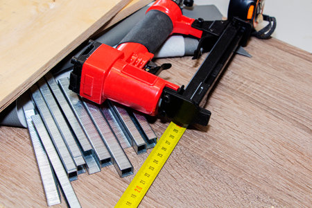 concept of furniture production and repair. Stapler and staples, working toolの写真素材