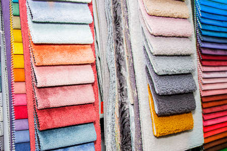 A set of fabric samples for furniture finishing. Multicolored upholstery stripes