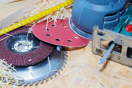 Carpentry tools on a wooden table with sawdust. saw on wood.