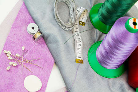 Pieces of cloth with scissors, needle and thread. Tailoring, manufacture of upholstered furniture.