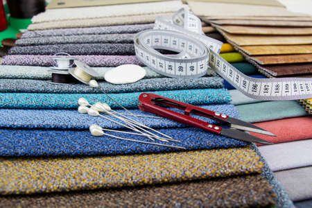 Pieces of cloth with scissors, needle and thread. Tailoring, manufacture of upholstered furnitureの写真素材