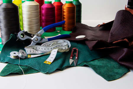 A piece of leather with scissors, needles, chalkの写真素材