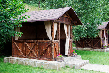 Gazebo in the garden. Wooden summer house. A place to relax.の写真素材