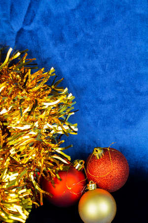 Christmas composition with Christmas toys in the form of balloons on a blue velvet background.の写真素材