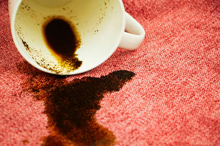 A spot on a light fabric, tablecloth, sofa. Washing, cleaning the fabric.の写真素材
