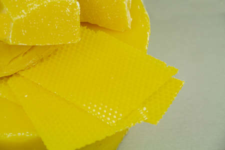 large pieces of natural beeswax, close-up, raw materials for candles.の写真素材