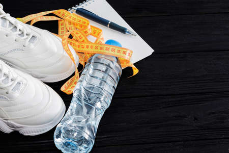 running shoes and a bottle of water on a black background. Healthy lifestyleの写真素材
