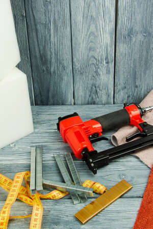 concept of furniture production and repair. Stapler and staples, working toolの写真素材