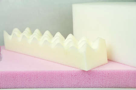 White sponge mattress material close-up. Inside the mattress