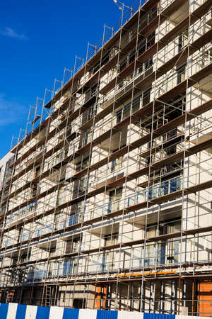 a fortified building under construction against a gray sky background