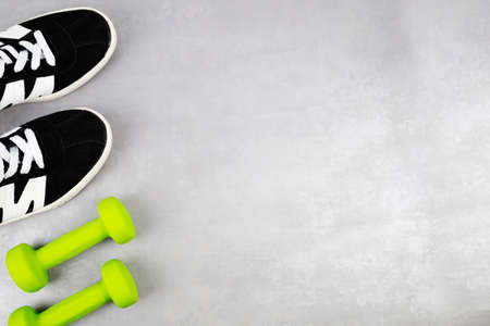 The background of the fitness concept with sneakers, dumbbells. Top view with a place for your textの写真素材