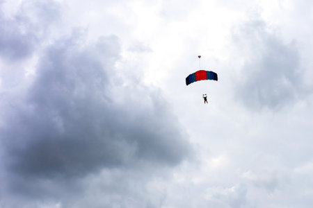 parachutist in a cloudy sky, an extreme sport. danger.の写真素材