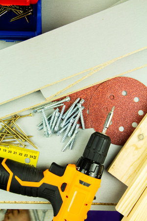 tools for repair and construction. Screwdriver, furniture screws, measuring tape, self-tapping...