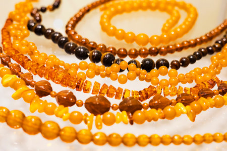 Round smooth beads made of natural honey Baltic amber.の写真素材