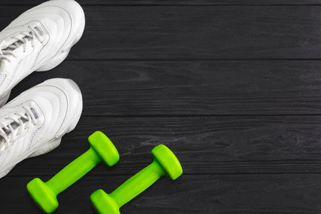 running shoes with dumbbells on a black background. Healthy lifestyleの写真素材