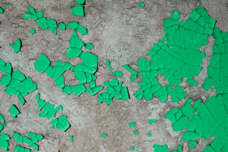 A close-up shot of a weathered surface with peeling revealing the rust underneath.の写真素材