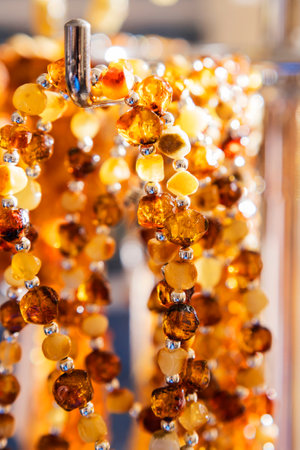Close up of amber bead necklace hanging on a hangerの写真素材