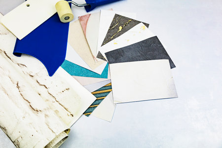 A variety of differently colored fabrics are spread out neatly across a table, showing their unique...