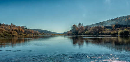 A picturesque view from the bank of the Sylva River on a bright autumn day. Photo taken in the...