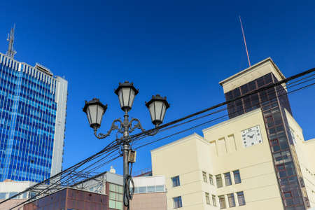 Lamppost on the background of buildings and the sky.のeditorial素材