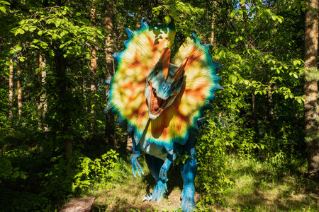 Chelyabinsk, Russia - June 01, 2022. A figure of a dinosaur with a flower around its neck stands in a park.のeditorial素材