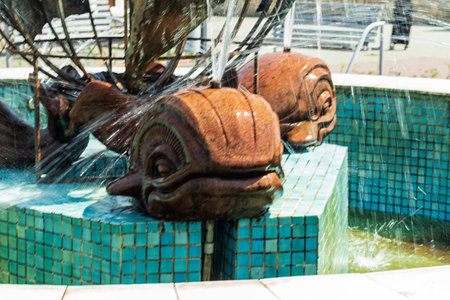 The active fountain represents three whales holding a model of the globe on their tail.の写真素材
