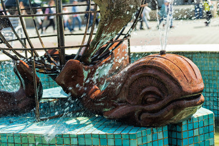 The active fountain represents three whales holding a model of the globe on their tail.の写真素材