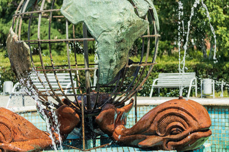 The active fountain represents three whales holding a model of the globe on their tail.の写真素材