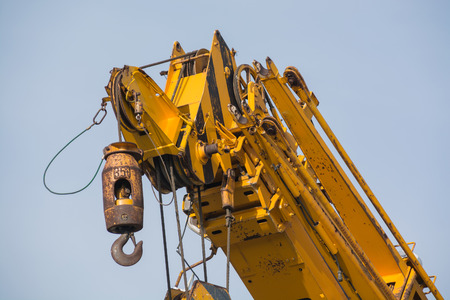 Yellow crane arm with hook close-upの写真素材