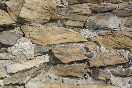 Stone Brick Wall made of fragment stones in irregular shapesの写真素材