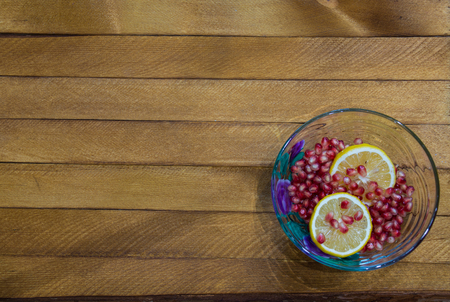 Transparent bowl full of lemon and garnetの写真素材