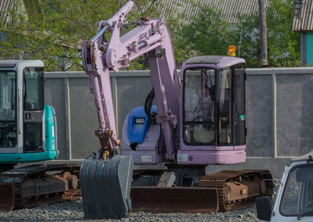 Pink excavator at a parking lotの写真素材