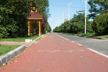 Bike path with white sign go away to horizont.の写真素材